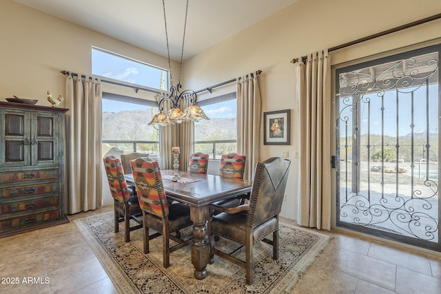 tiled dining room featuring a mountain view and a notable chandelier