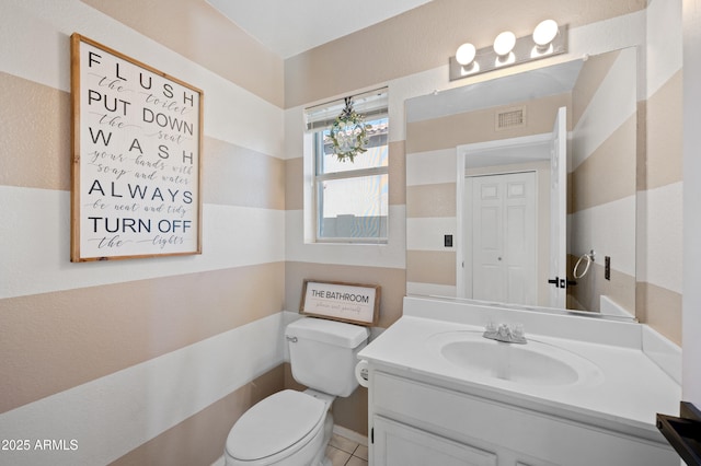 bathroom featuring tile patterned floors, vanity, and toilet