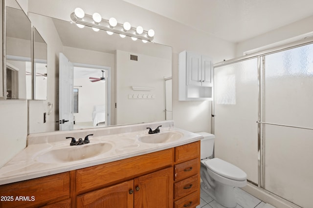 bathroom featuring vanity, tile patterned floors, ceiling fan, toilet, and an enclosed shower