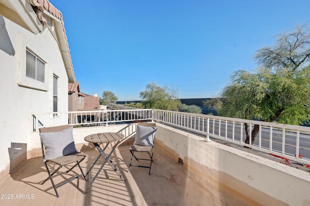 view of patio featuring a balcony