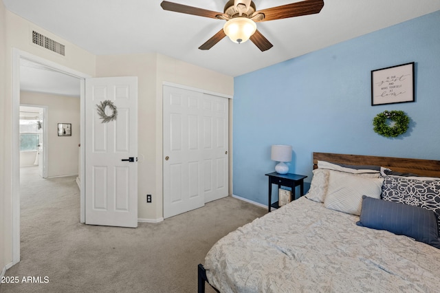 bedroom featuring light carpet, a closet, and ceiling fan