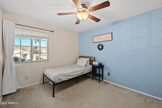 bedroom featuring ceiling fan and light carpet