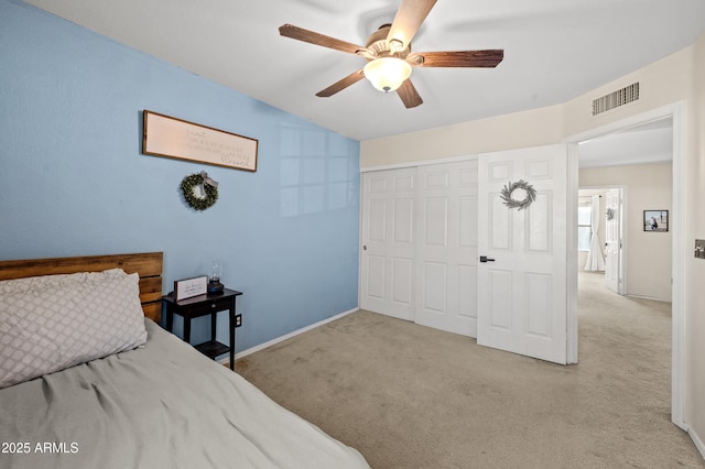 carpeted bedroom featuring ceiling fan and a closet