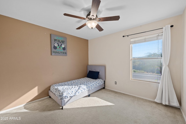 bedroom with ceiling fan and light colored carpet