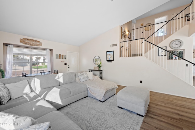 living room featuring hardwood / wood-style floors and lofted ceiling