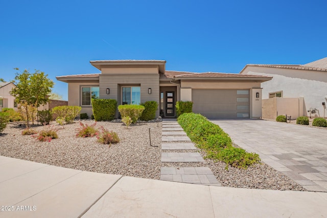 6356 S Granite St, Gilbert, AZ 85298 - prairie-style house featuring a garage, decorative driveway, and stucco siding
