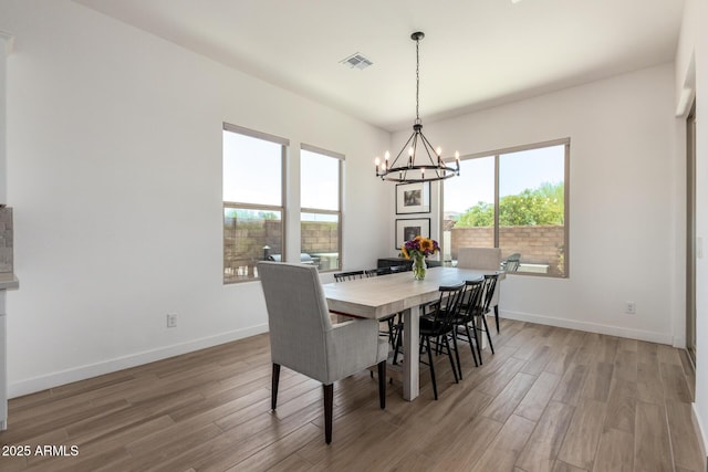 6356 S Granite St, Gilbert, AZ 85298 - dining space with light wood-style flooring, a chandelier, and baseboards