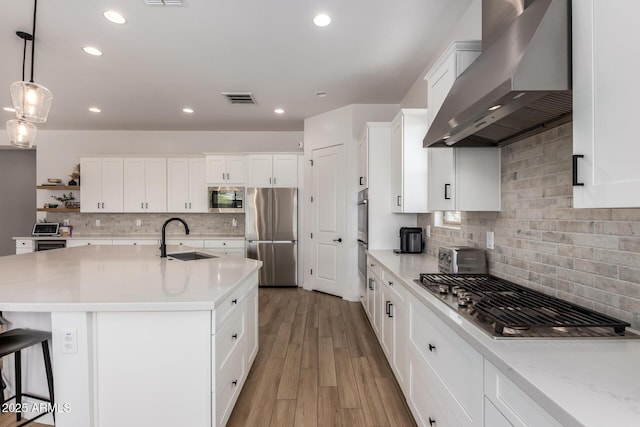 6356 S Granite St, Gilbert, AZ 85298 - kitchen featuring wall chimney range hood, appliances with stainless steel finishes, a sink, tasteful backsplash, and white cabinets