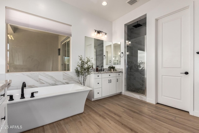 6356 S Granite St, Gilbert, AZ 85298 - full bath featuring vanity, a shower stall, a soaking tub, wood finished floors, and recessed lighting