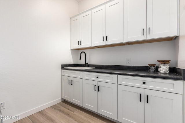 6356 S Granite St, Gilbert, AZ 85298 - bar with a sink, light wood finished floors, and baseboards