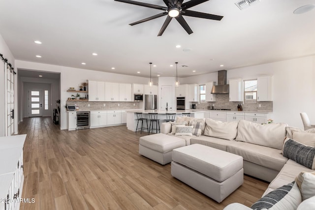 6356 S Granite St, Gilbert, AZ 85298 - living area featuring wine cooler, recessed lighting, a ceiling fan, and light wood finished floors
