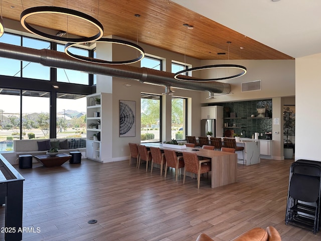 6356 S Granite St, Gilbert, AZ 85298 - living area with light wood-type flooring, a high ceiling, wood ceiling, and baseboards