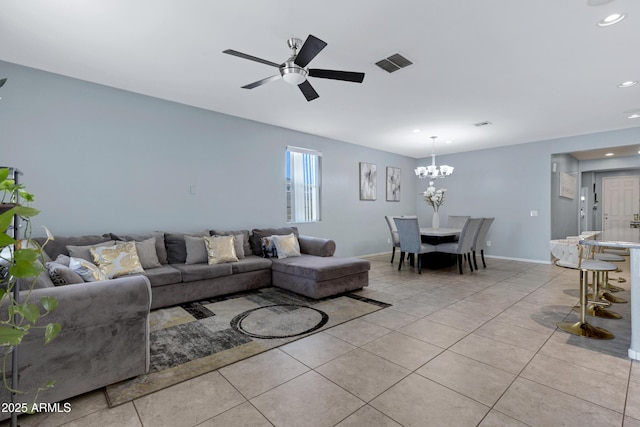 living room featuring light tile patterned flooring and ceiling fan with notable chandelier