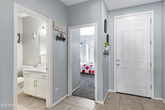 foyer entrance with light colored carpet