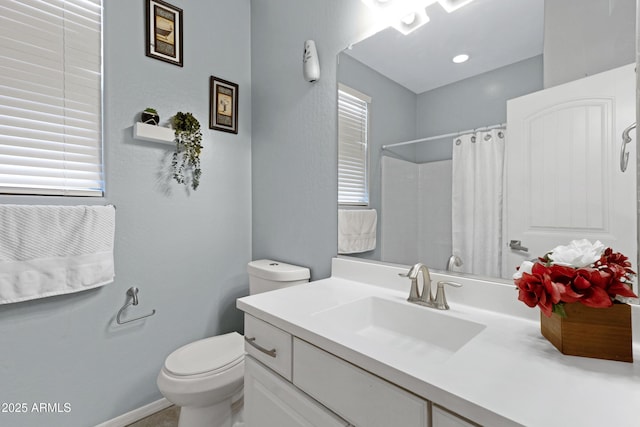 bathroom featuring toilet, a wealth of natural light, vanity, and a shower with shower curtain