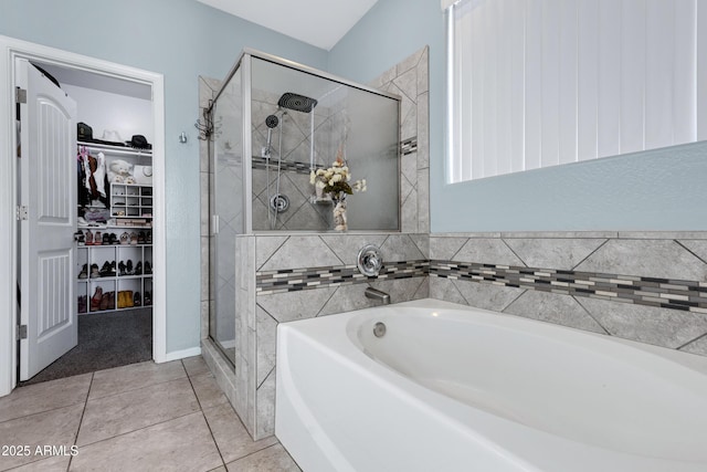 bathroom featuring tile patterned floors and separate shower and tub