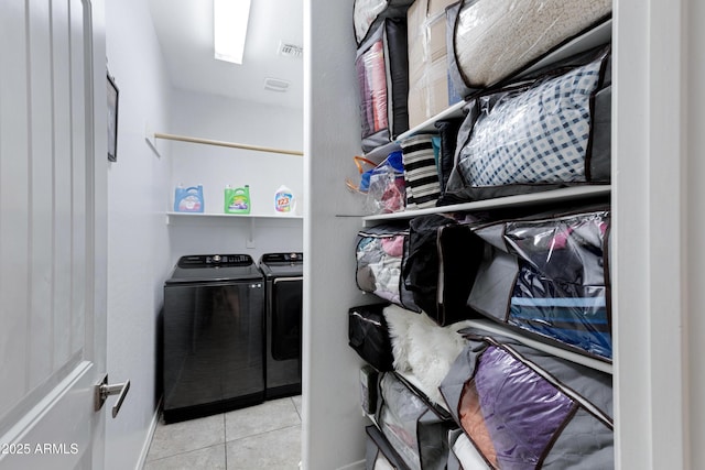 washroom with washer and dryer and light tile patterned floors