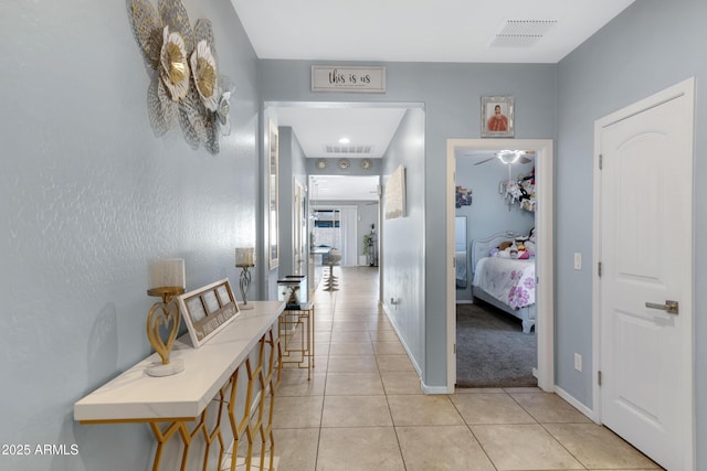 hallway featuring light tile patterned flooring