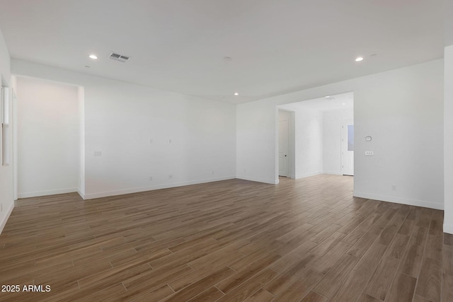 unfurnished room with dark hardwood / wood-style floors