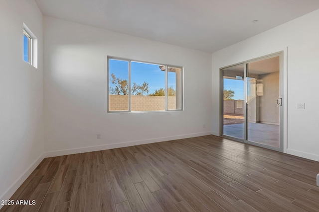 unfurnished room with wood-type flooring