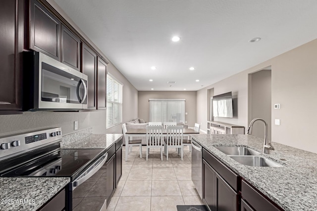 18800 W Madison St, Buckeye, AZ 85326 - kitchen with light stone countertops, light tile patterned flooring, stainless steel appliances, a sink, and recessed lighting