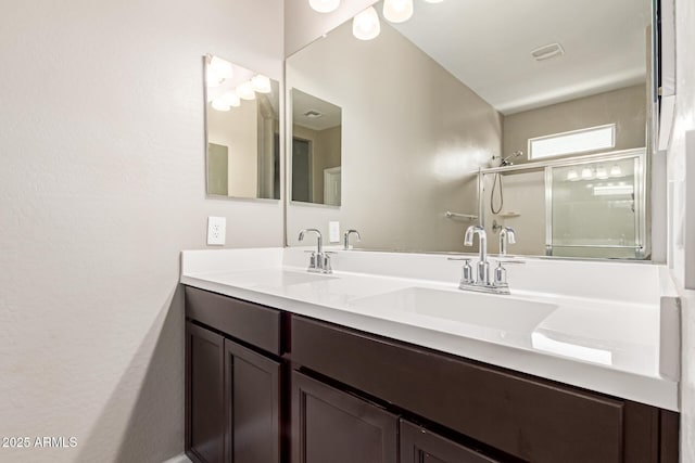 18800 W Madison St, Buckeye, AZ 85326 - bathroom featuring visible vents, a sink, a shower stall, and double vanity