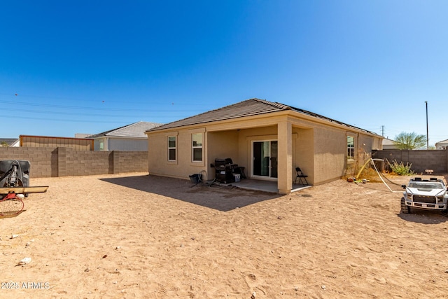 18800 W Madison St, Buckeye, AZ 85326 - rear view of property with a patio area, a fenced backyard, and stucco siding