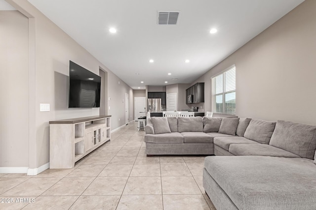 18800 W Madison St, Buckeye, AZ 85326 - living room featuring light tile patterned floors, baseboards, visible vents, and recessed lighting