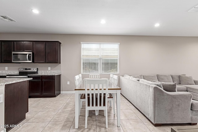 18800 W Madison St, Buckeye, AZ 85326 - kitchen featuring dark brown cabinetry, visible vents, appliances with stainless steel finishes, and open floor plan