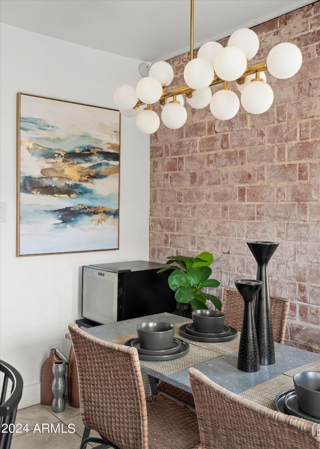 dining area featuring tile patterned floors and an inviting chandelier