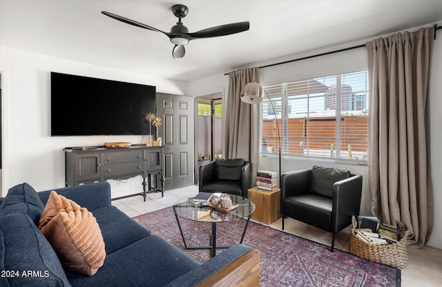 tiled living room featuring ceiling fan