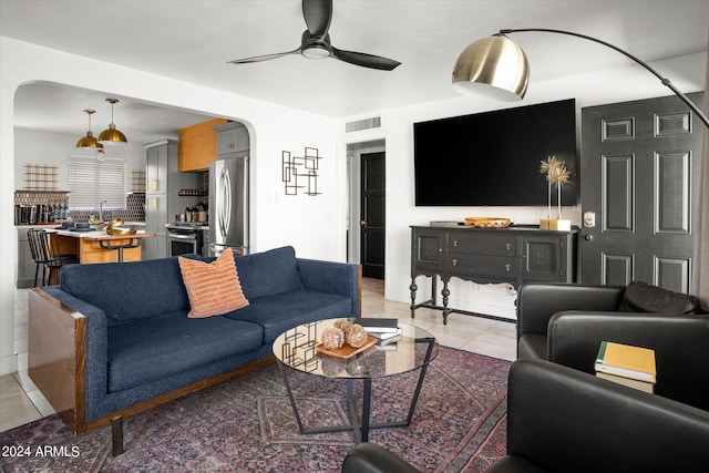 living room with ceiling fan and light tile patterned flooring