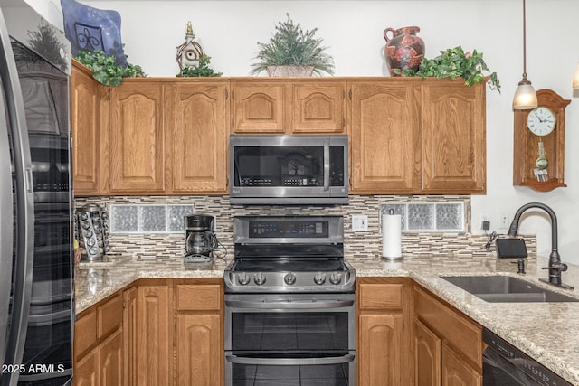 kitchen featuring decorative backsplash, sink, hanging light fixtures, and black appliances