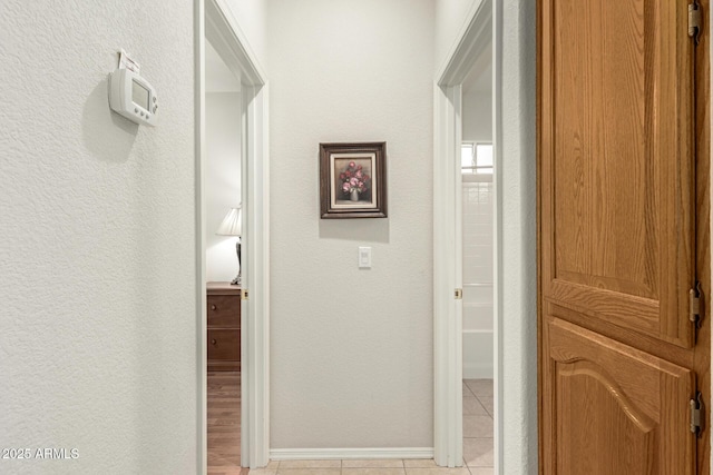 corridor with light tile patterned flooring