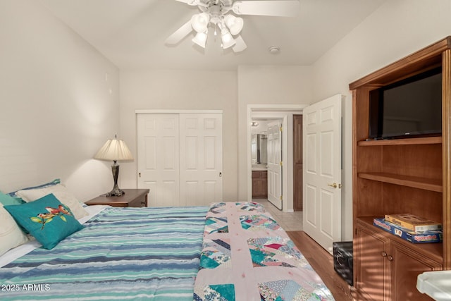 bedroom with ceiling fan, a closet, and light hardwood / wood-style floors