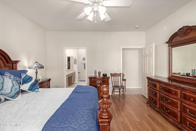 bedroom featuring ceiling fan, connected bathroom, and light hardwood / wood-style flooring