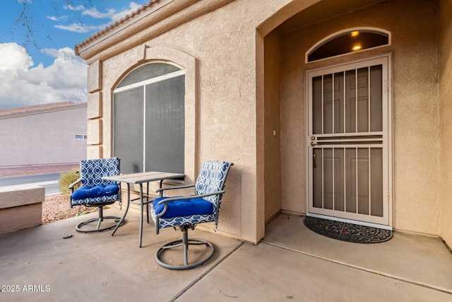 doorway to property with a patio