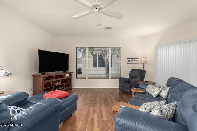 living room with dark hardwood / wood-style flooring and ceiling fan