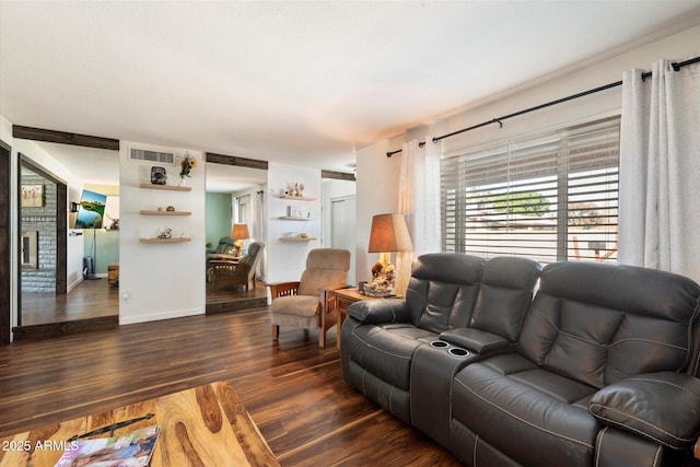 living room with dark hardwood / wood-style floors and a fireplace