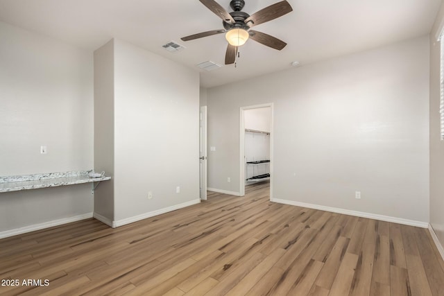 unfurnished room featuring ceiling fan and light wood-type flooring