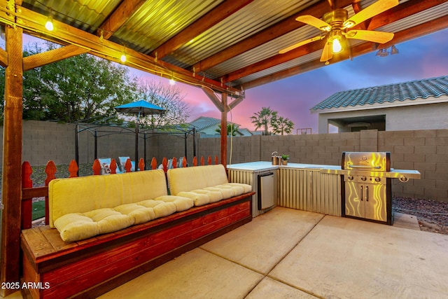 patio terrace at dusk featuring a gazebo, ceiling fan, a grill, and an outdoor living space