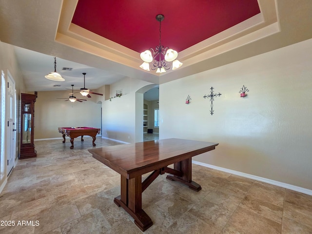 recreation room featuring ceiling fan, arched walkways, pool table, baseboards, and a tray ceiling