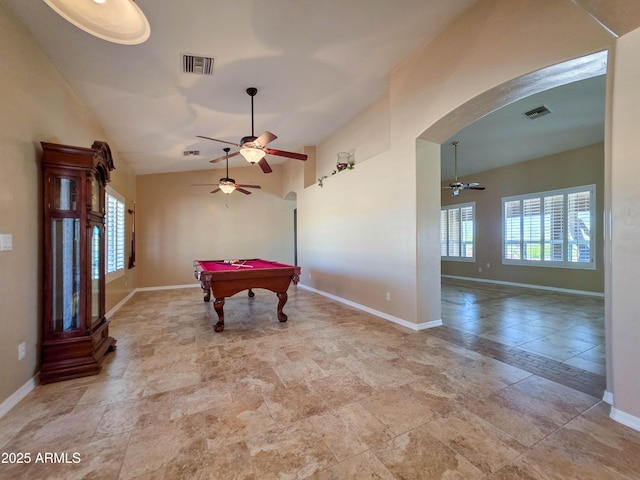 rec room with arched walkways, ceiling fan, lofted ceiling, and visible vents