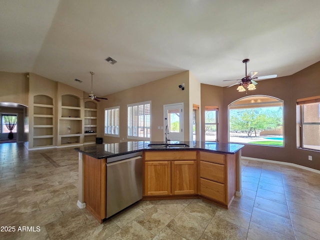 kitchen with stainless steel dishwasher, open floor plan, a sink, and ceiling fan