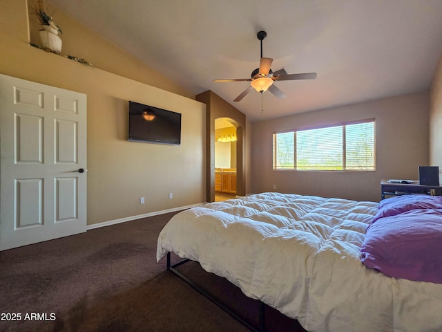 carpeted bedroom with a ceiling fan, baseboards, arched walkways, ensuite bath, and vaulted ceiling