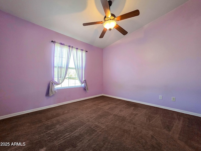 empty room featuring dark carpet, baseboards, ceiling fan, and lofted ceiling