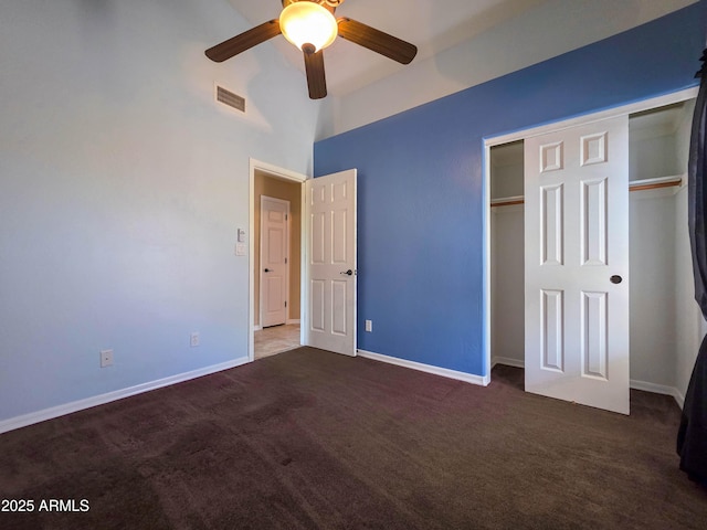 unfurnished bedroom featuring carpet floors, baseboards, visible vents, and a closet