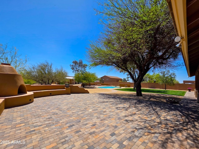 view of patio featuring a fenced in pool and a fenced backyard