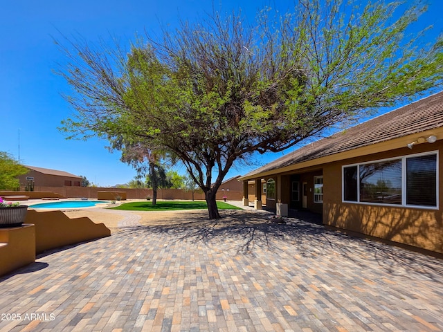 view of patio featuring a fenced in pool and a fenced backyard