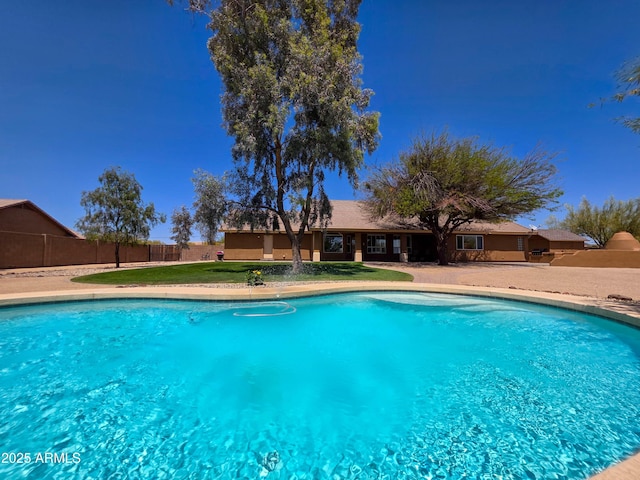 view of swimming pool with a fenced in pool, fence, and a yard